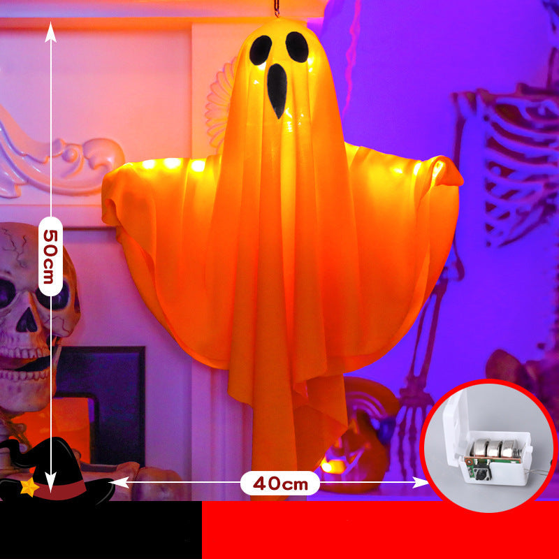 An inflatable hanging ghost Halloween decoration glowing with warm orange light, shown in a decorated room with dimension labels indicating 50 cm height and 40 cm width. The image includes a circular inset showing the battery compartment.