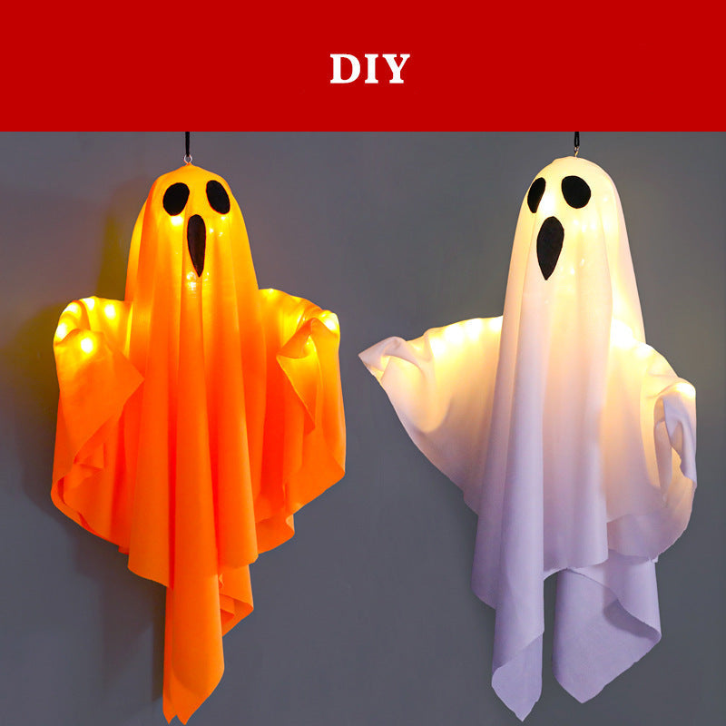 Two DIY hanging ghost decorations with integrated LED lights, one orange and one white, shown against a dark gray background.
